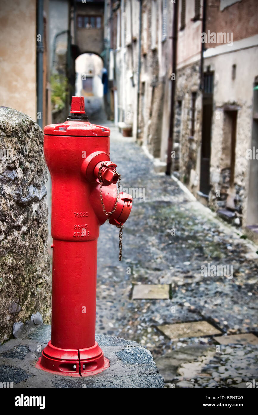 Red hydrant in Saorge, France. Stock Photo