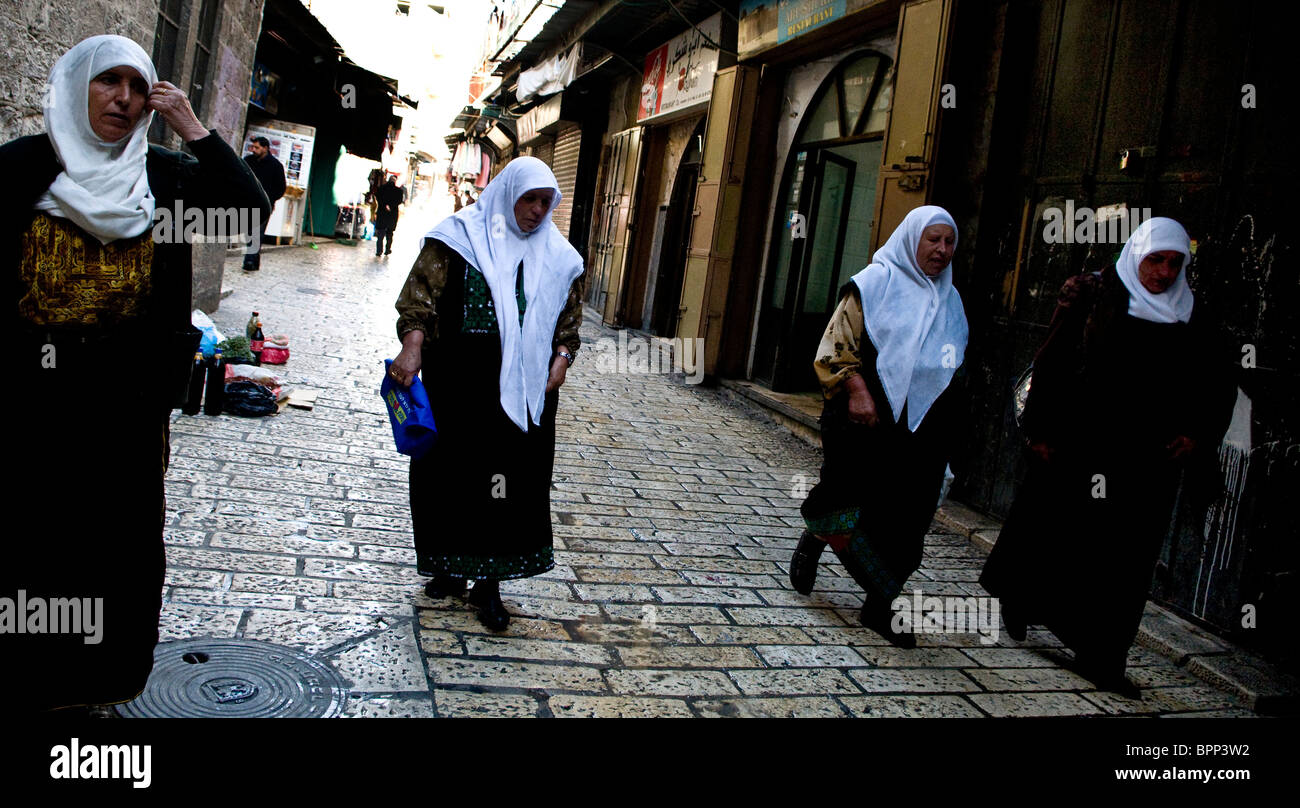 Four Palestinian women walking to the Al Aqsa mosque located on the temple mt. for the Friday prayers. Stock Photo