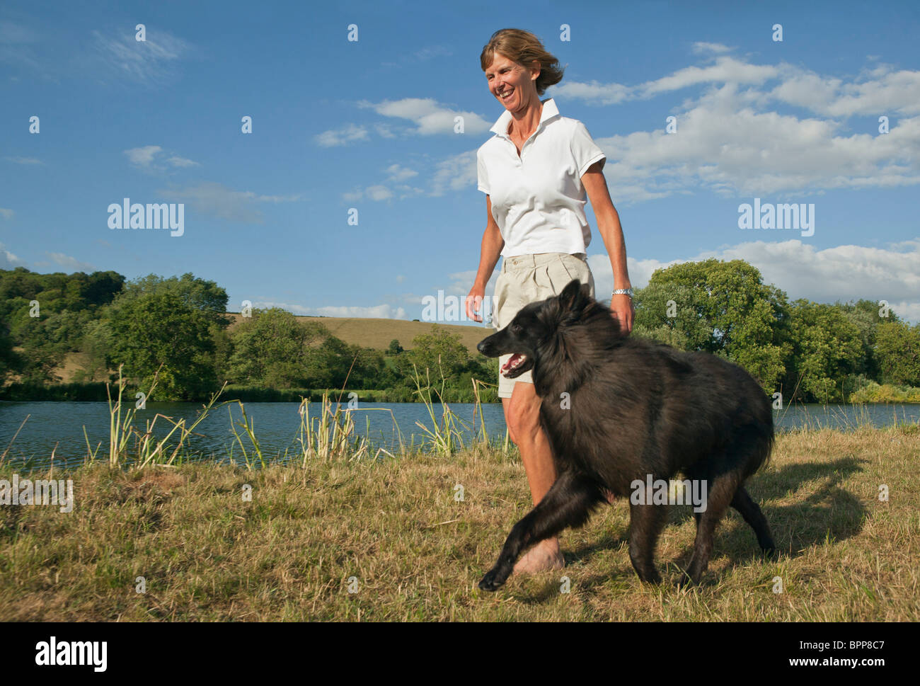 Mature lady walking dog hi-res stock photography and images - Alamy