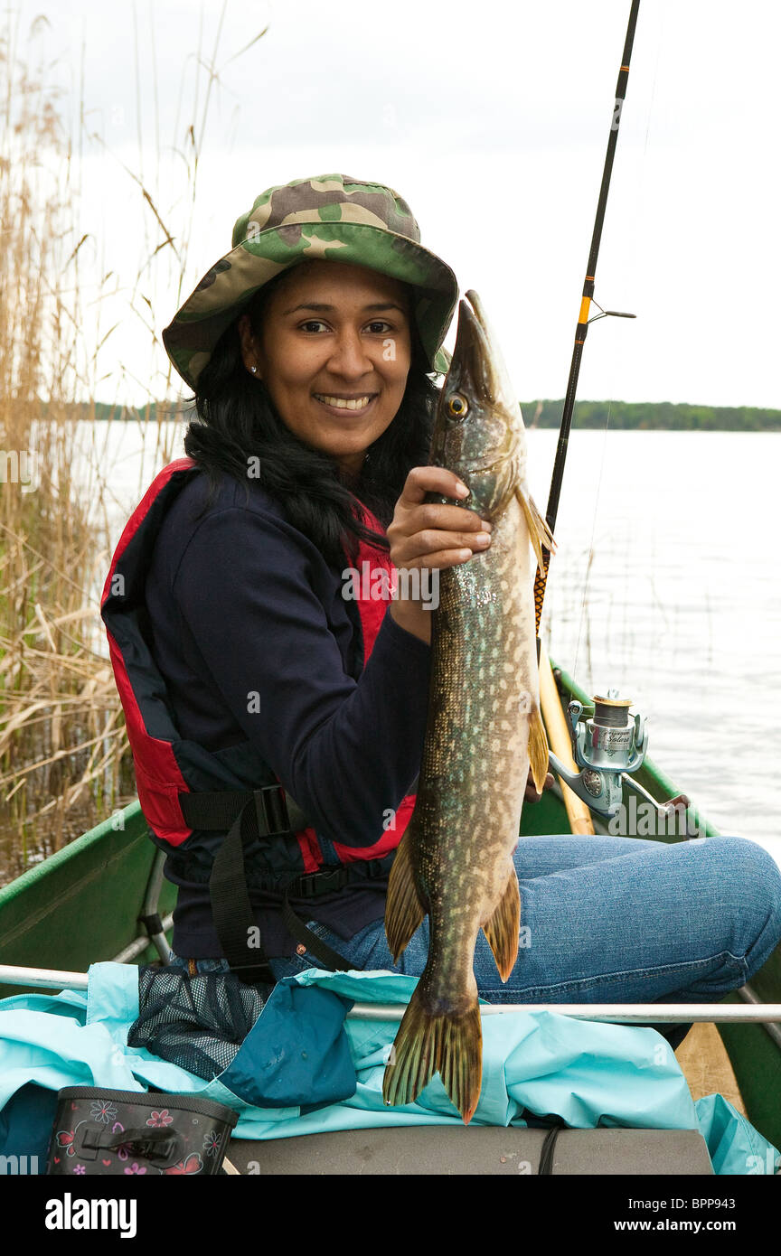 Girl with a a Northern Pike, Esox lucius, caught in the lake Vansjø in Østfold, Norway. Vansjø is a part of the water system called Morsavassdraget. Stock Photo