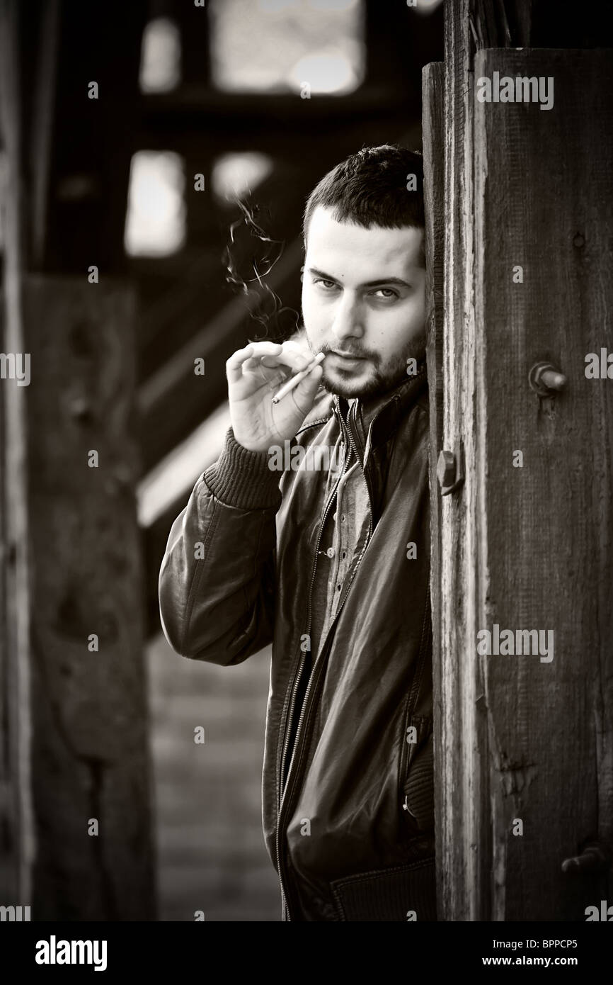 Vintage portrait of an attractive young man smoking Stock Photo - Alamy