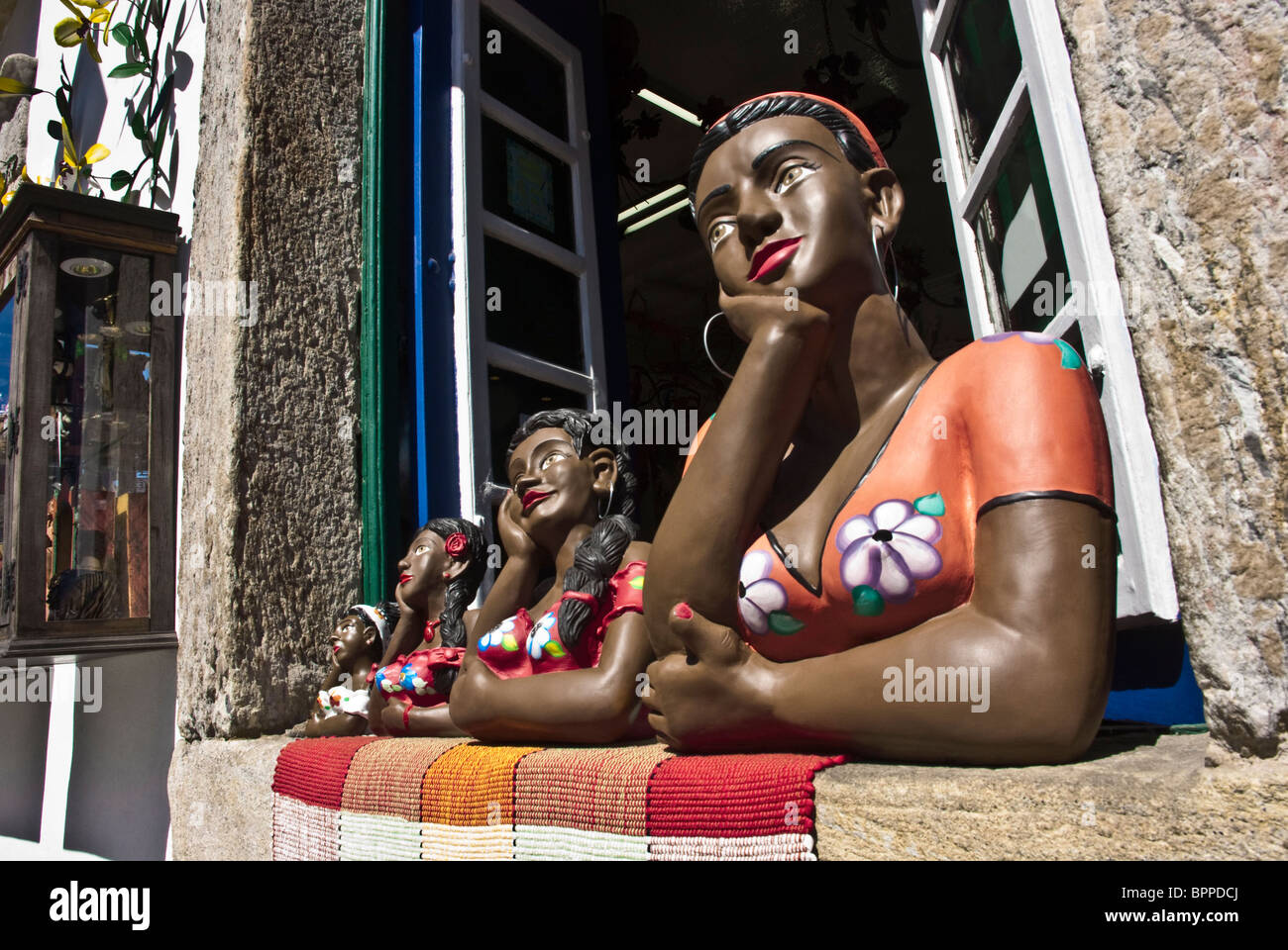 A row of namoradeiras in window of store in Ouro Preto, Brazil Stock Photo