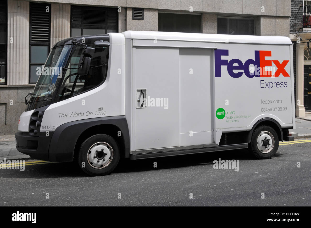 Side view FedEx Express all electric zero emission Fed Ex parcel delivery business van lorry truck parked in street in London England UK Stock Photo