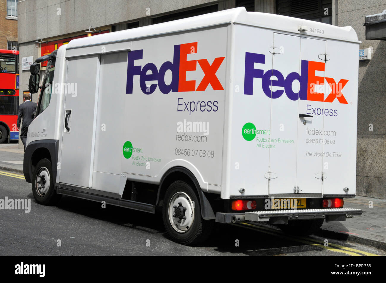 Side back rear view FedEx Express brand all electric zero emission  parcel delivery business van lorry truck parked in street in London England UK Stock Photo