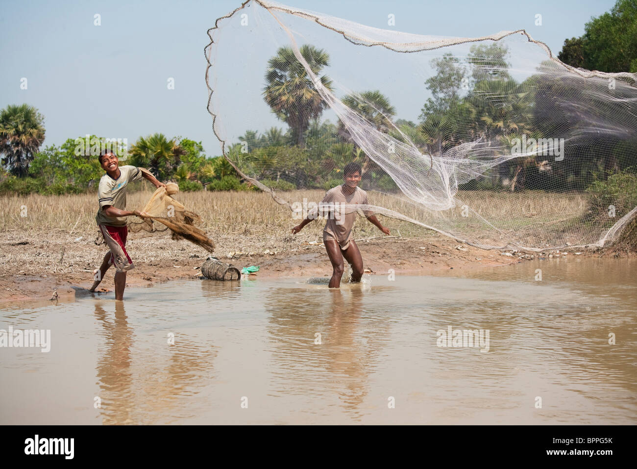 Fishermen putting out a fishing net in the Sangkae river