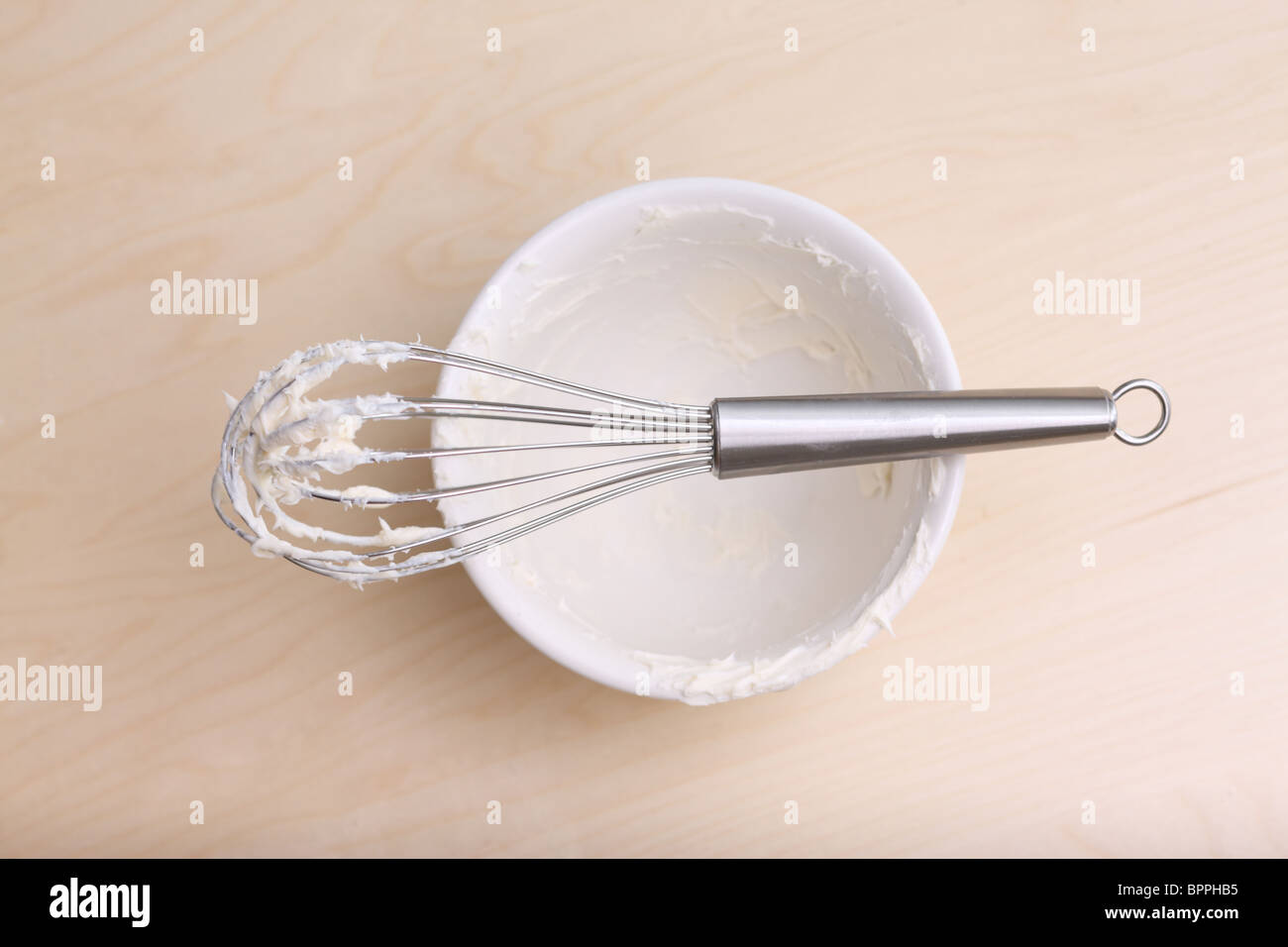 Empty bowl of batter and whisk Stock Photo