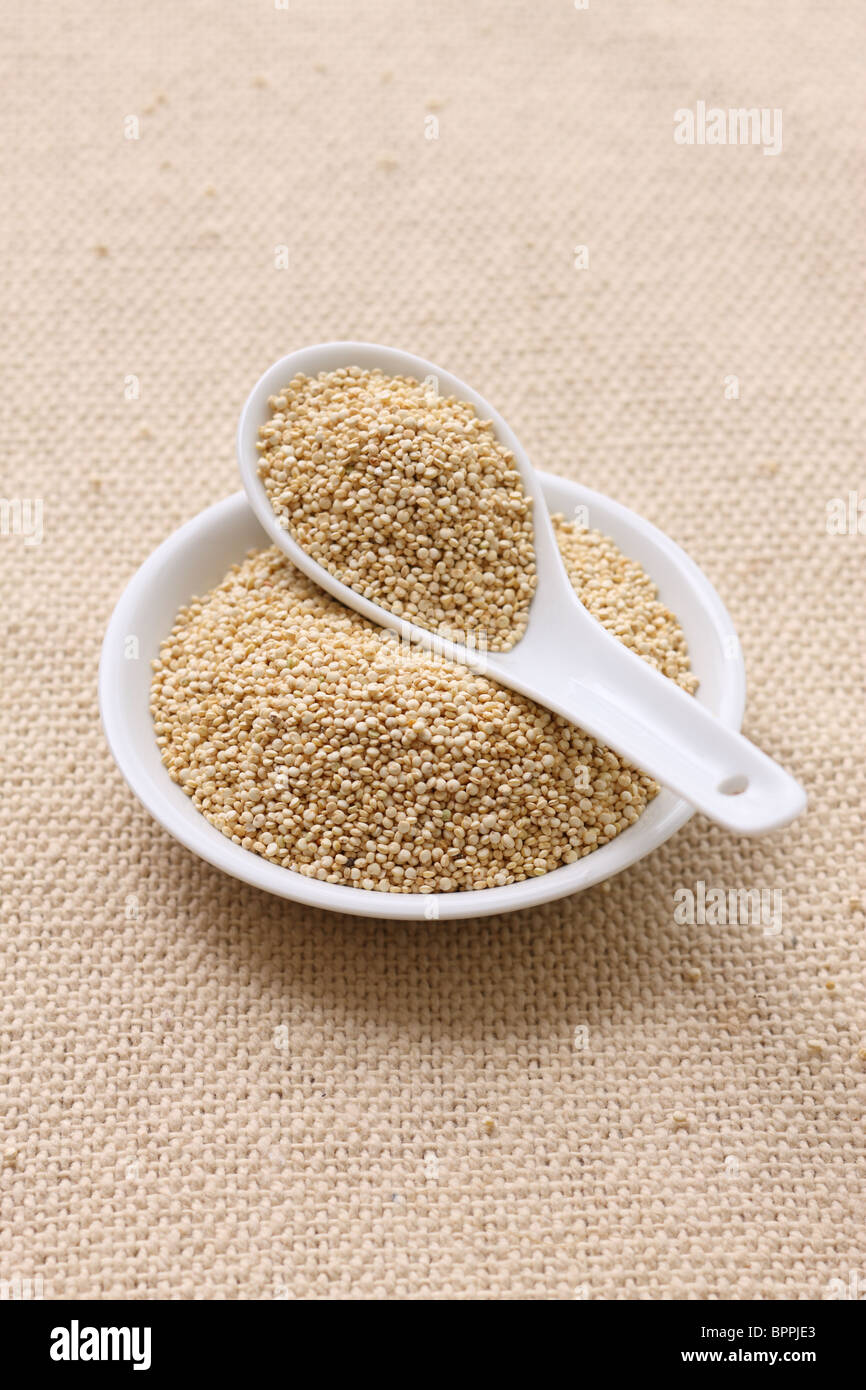Quinoa in small bowl and spoon Stock Photo