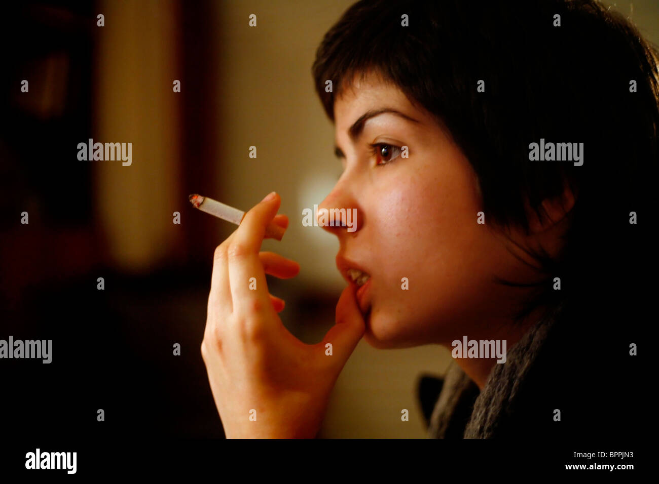 A woman smoking and thinking Stock Photo