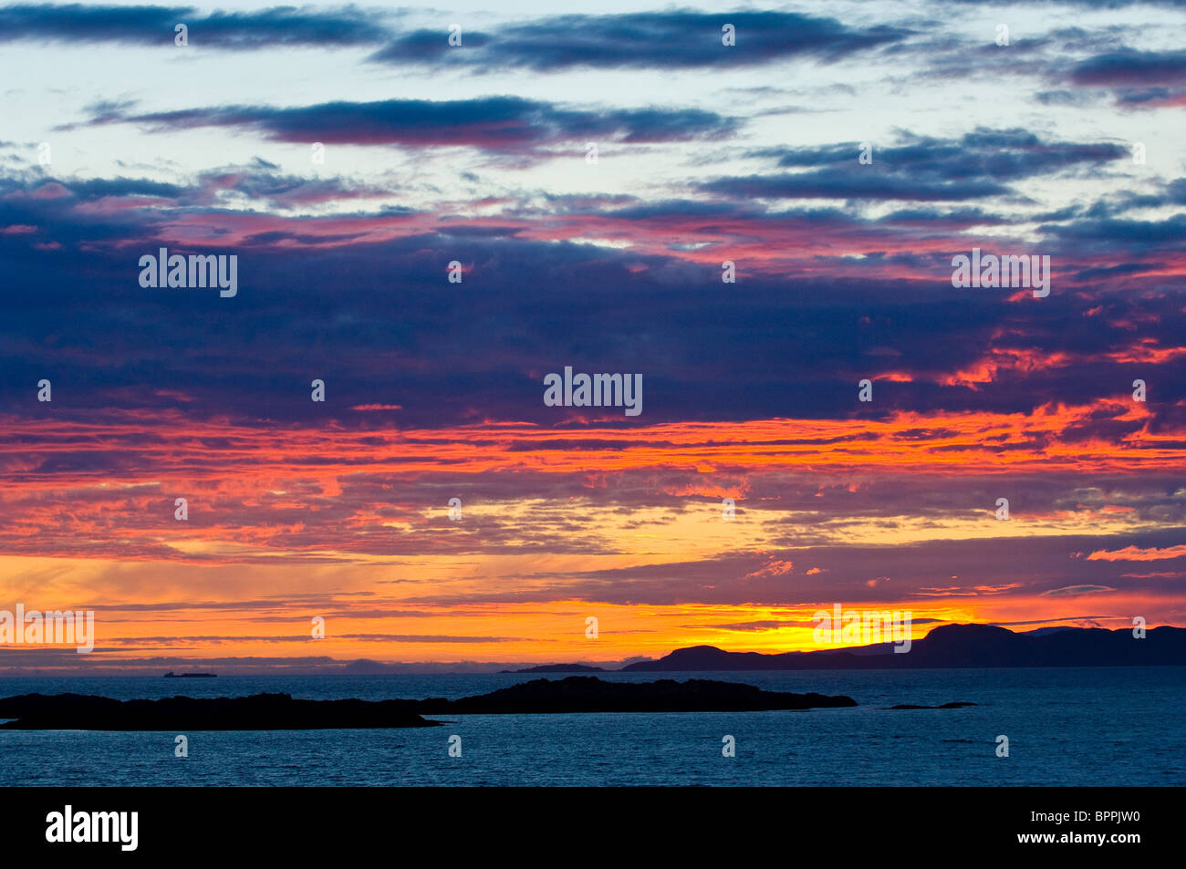 Sunset over the Isle of Rum and Isle of Skye from, Arisaig, Scotland Stock Photo