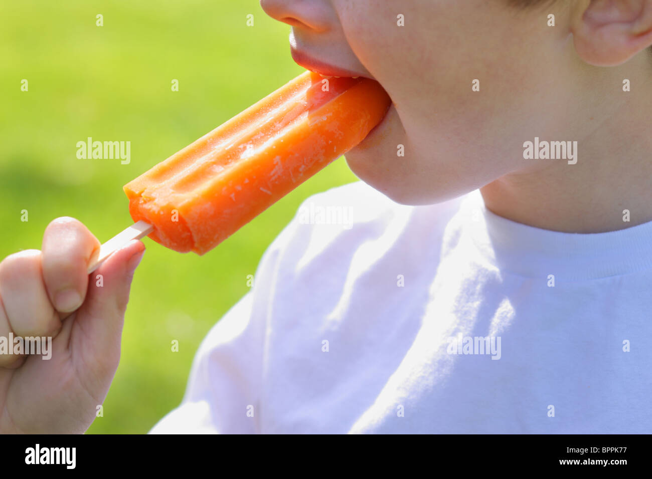 Closeup of child eating Popsicle Stock Photo