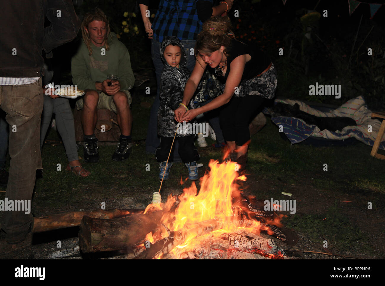 Kids around a bonfire Stock Photo Alamy