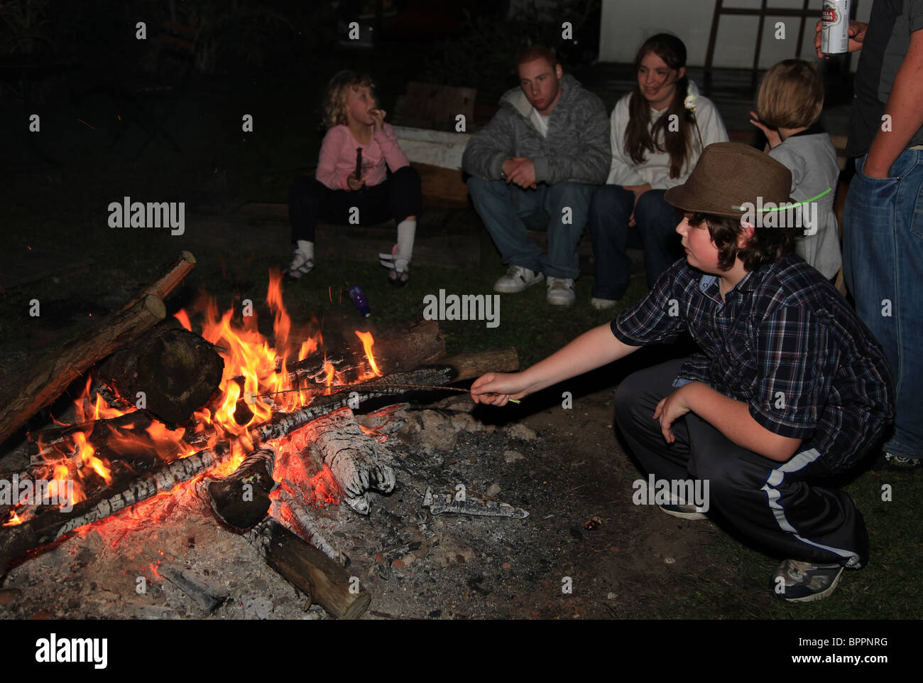 Kids around a bonfire Stock Photo Alamy
