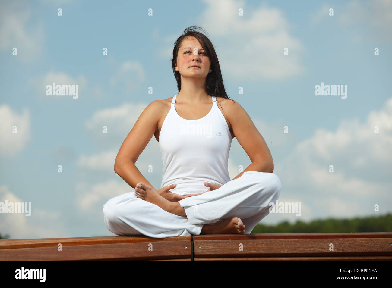 Yoga 'half lotus pose' / yoga exercise Stock Photo Alamy