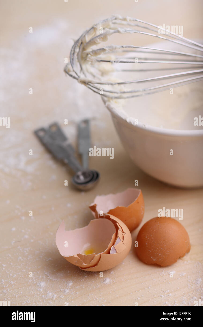 Baking stuff; egg shells, measuring spoons and whisk Stock Photo
