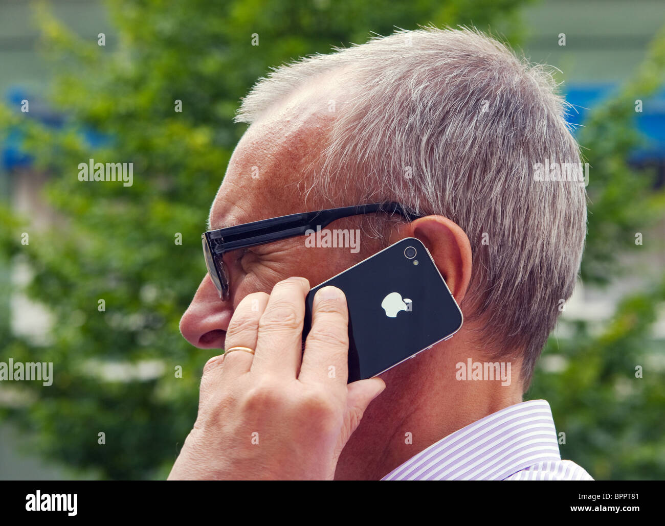 Man talking in his iPhone 4. Stock Photo