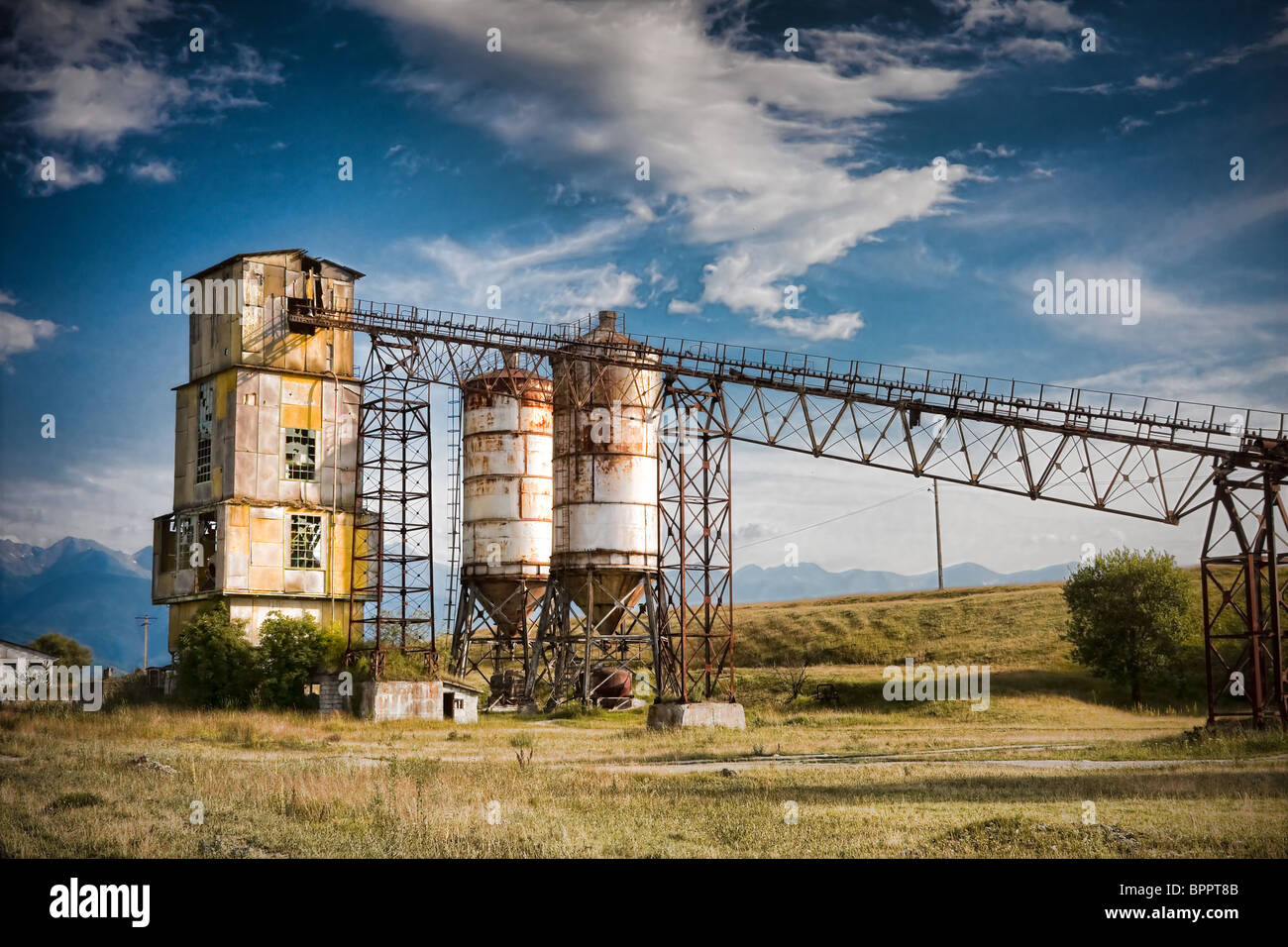 Old rock crushing machines in a abandoned quarry Stock Photo