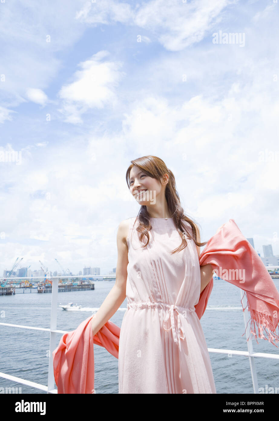 Young woman under blue sky Stock Photo - Alamy