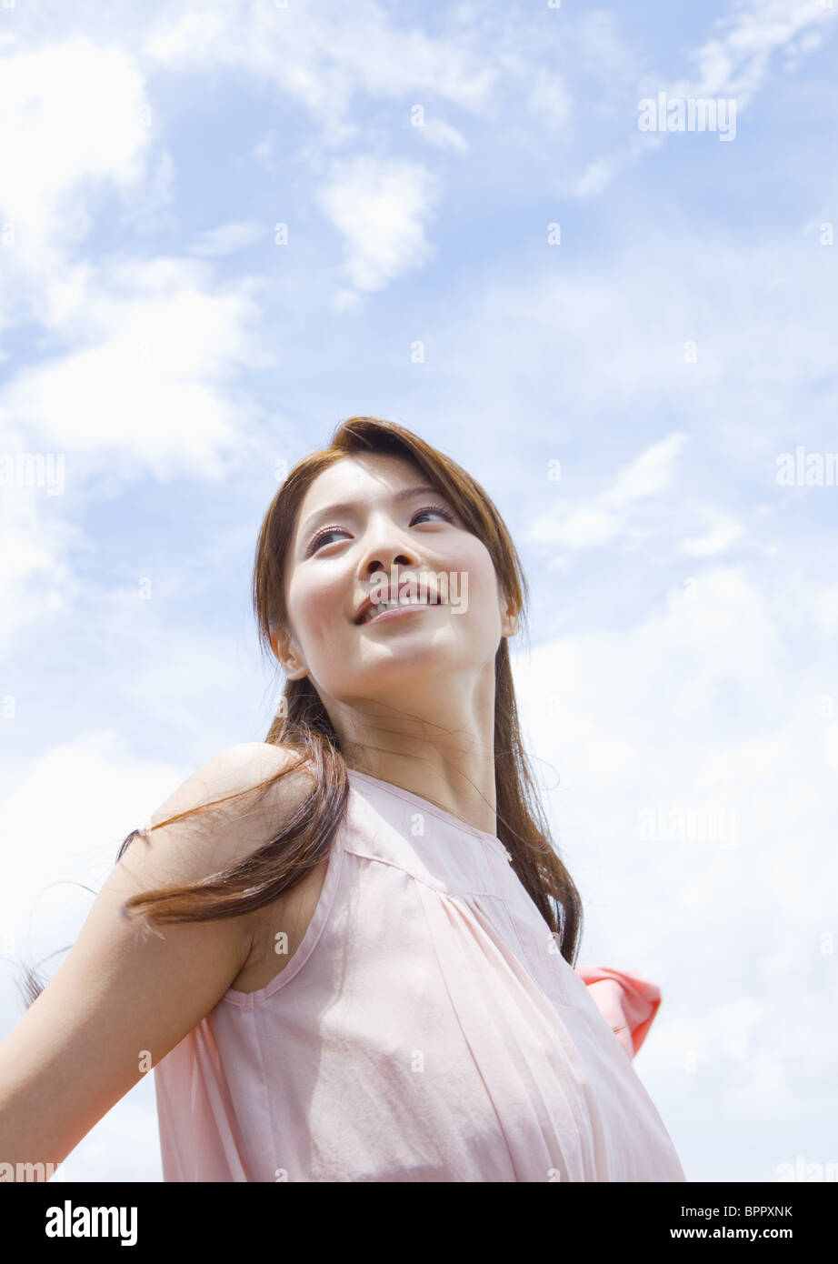 Young woman under blue sky Stock Photo - Alamy