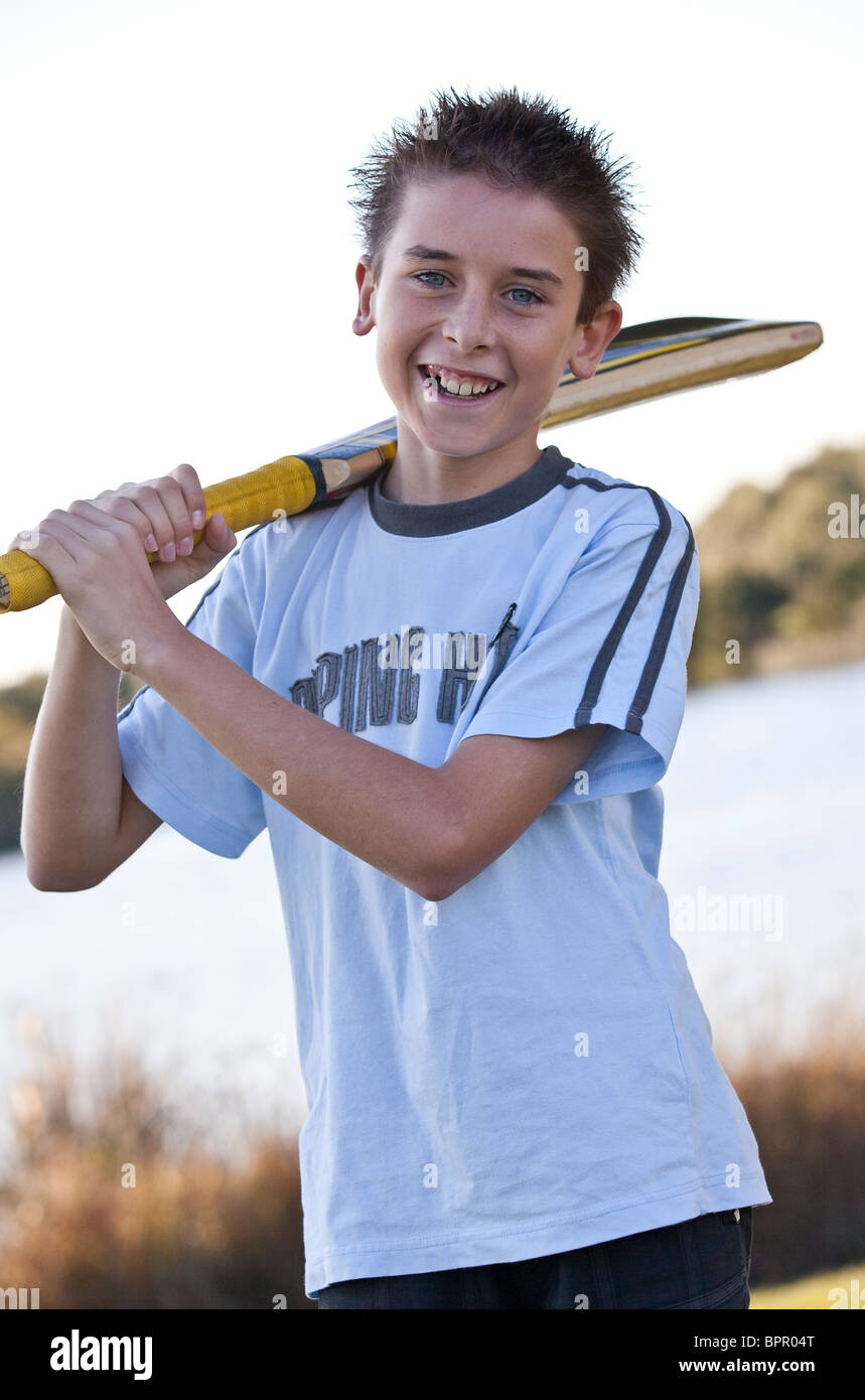 Young teenage boy holding cricket bat Stock Photo