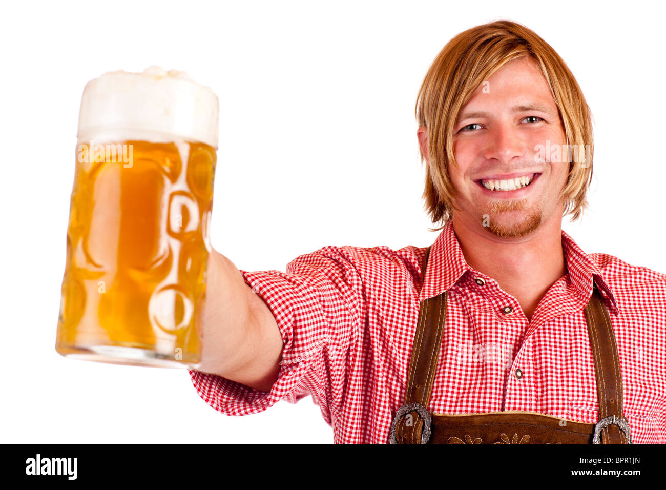 Happy smiling man with leather trousers (lederhose) holds Oktoberfest beer stein. Isolated on white background. Stock Photo