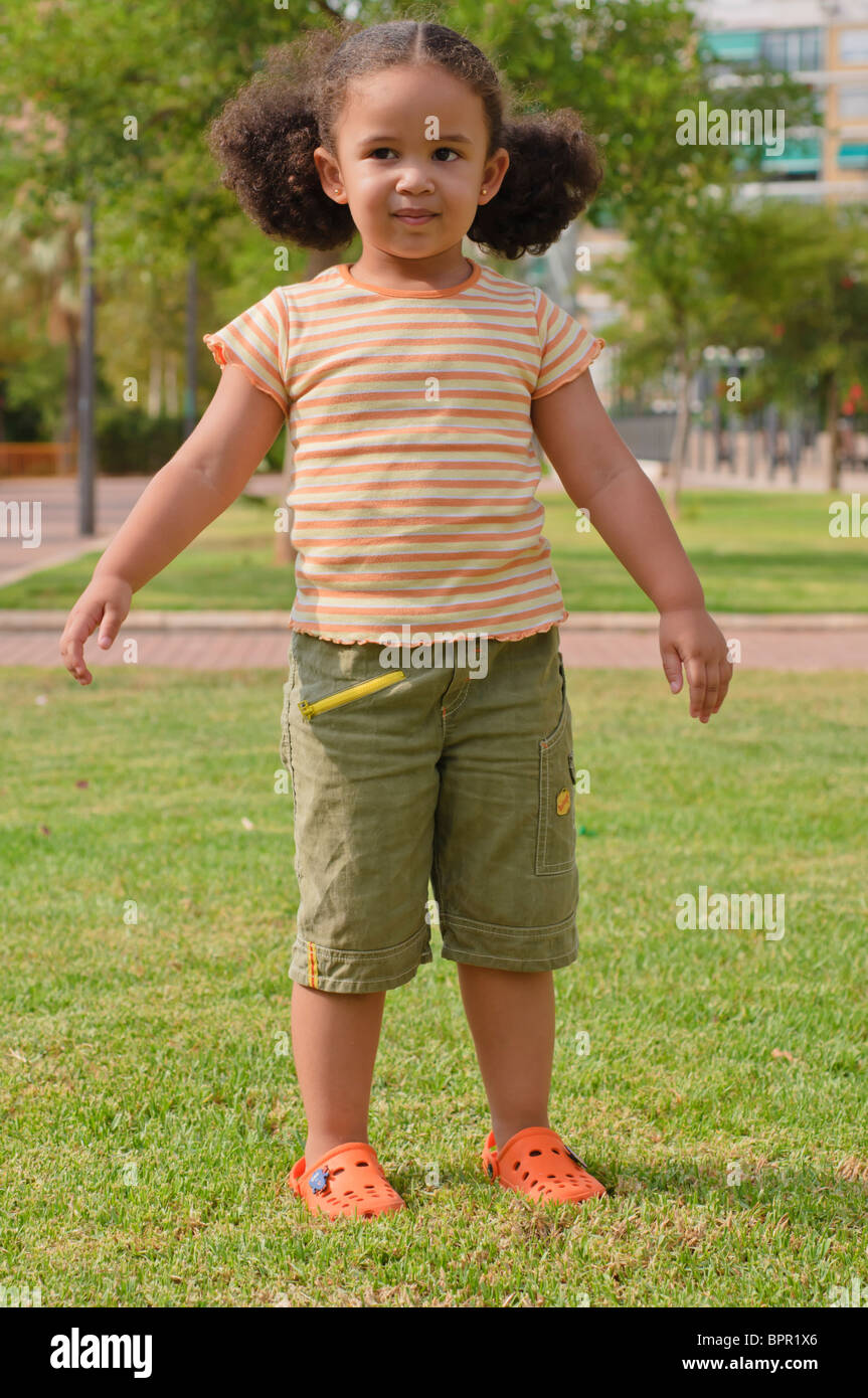 Young girl playing in the park Stock Photo - Alamy