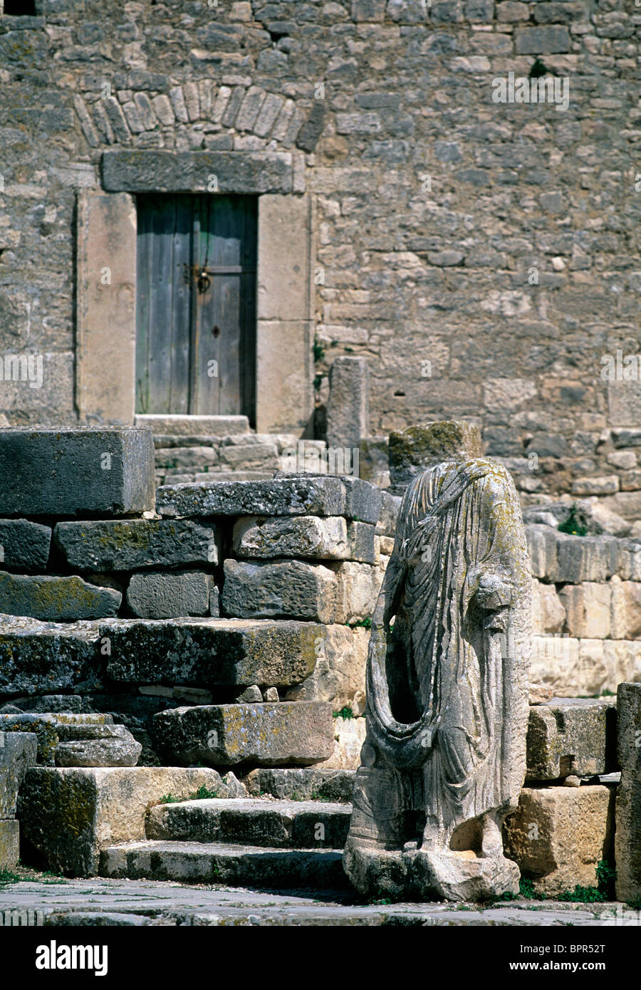 Headless Roman statue near the Temple of August Piety at the UNESCO