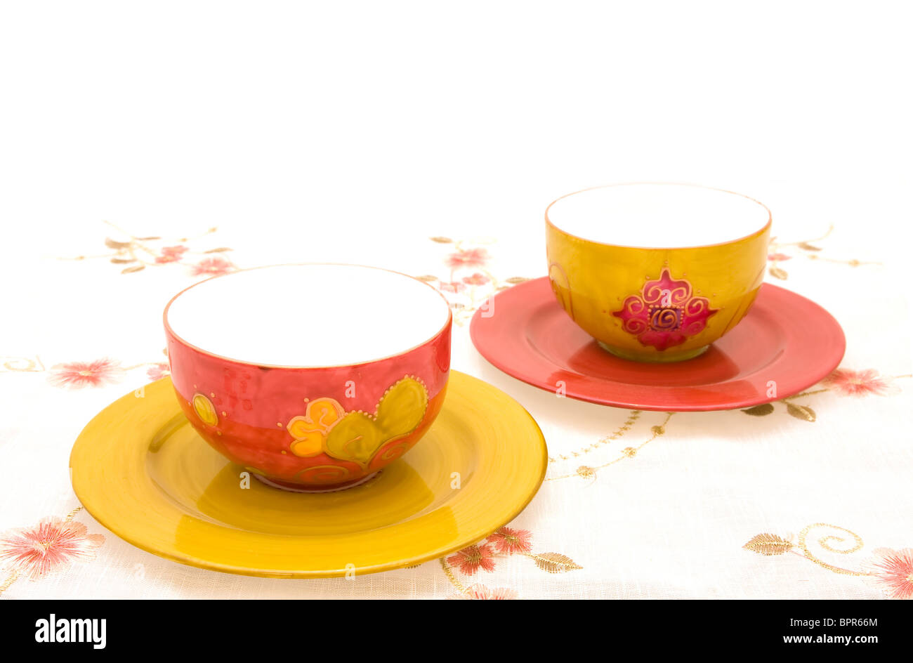 Handmade porcelain tea cups on the table. Stock Photo