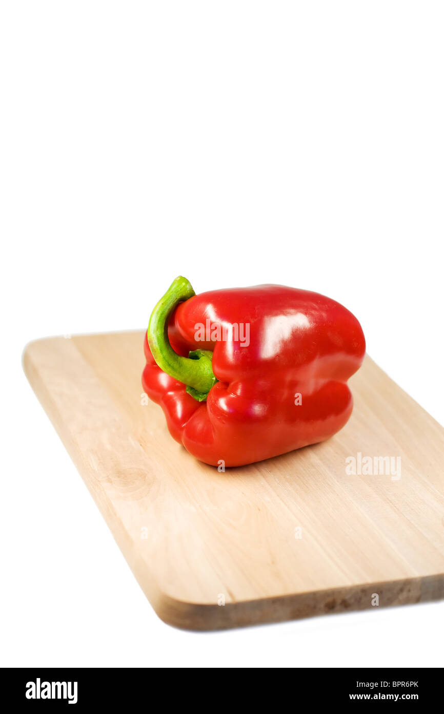 Red pepper on a wooden cutting board. Stock Photo