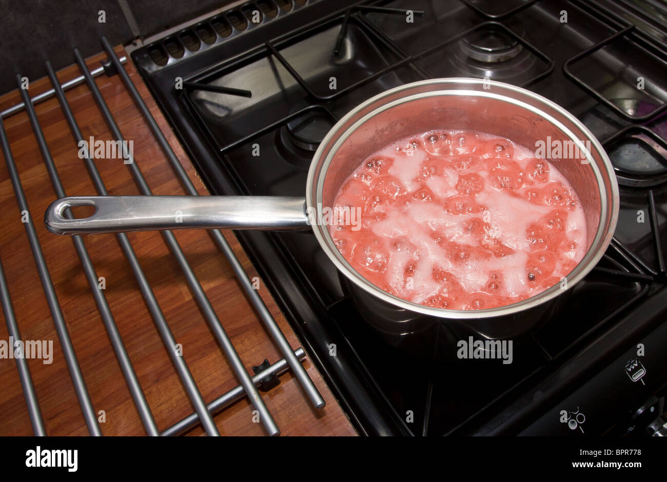 Home made strawberry jam being cooked up on stove Stock Photo Alamy