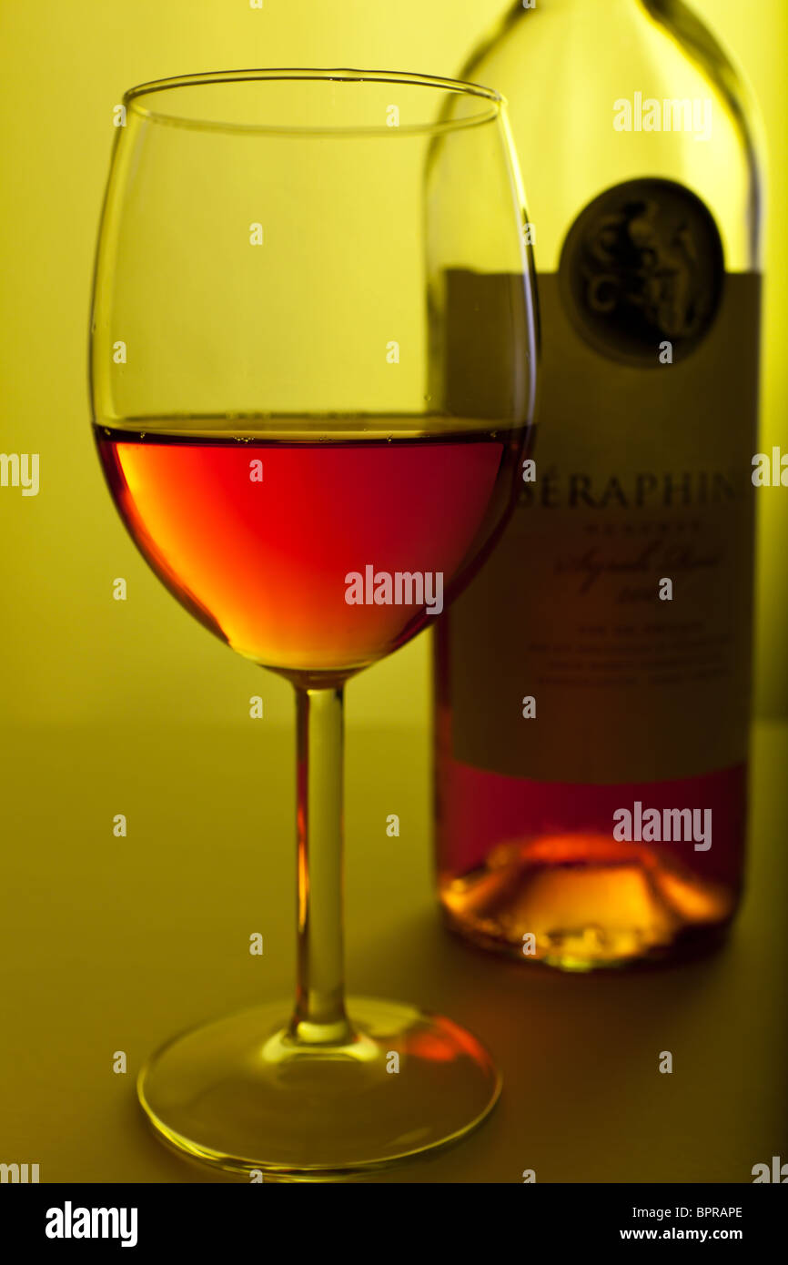 A studio shot of a glass of rose wine with the wine bottle behind it Stock Photo Alamy