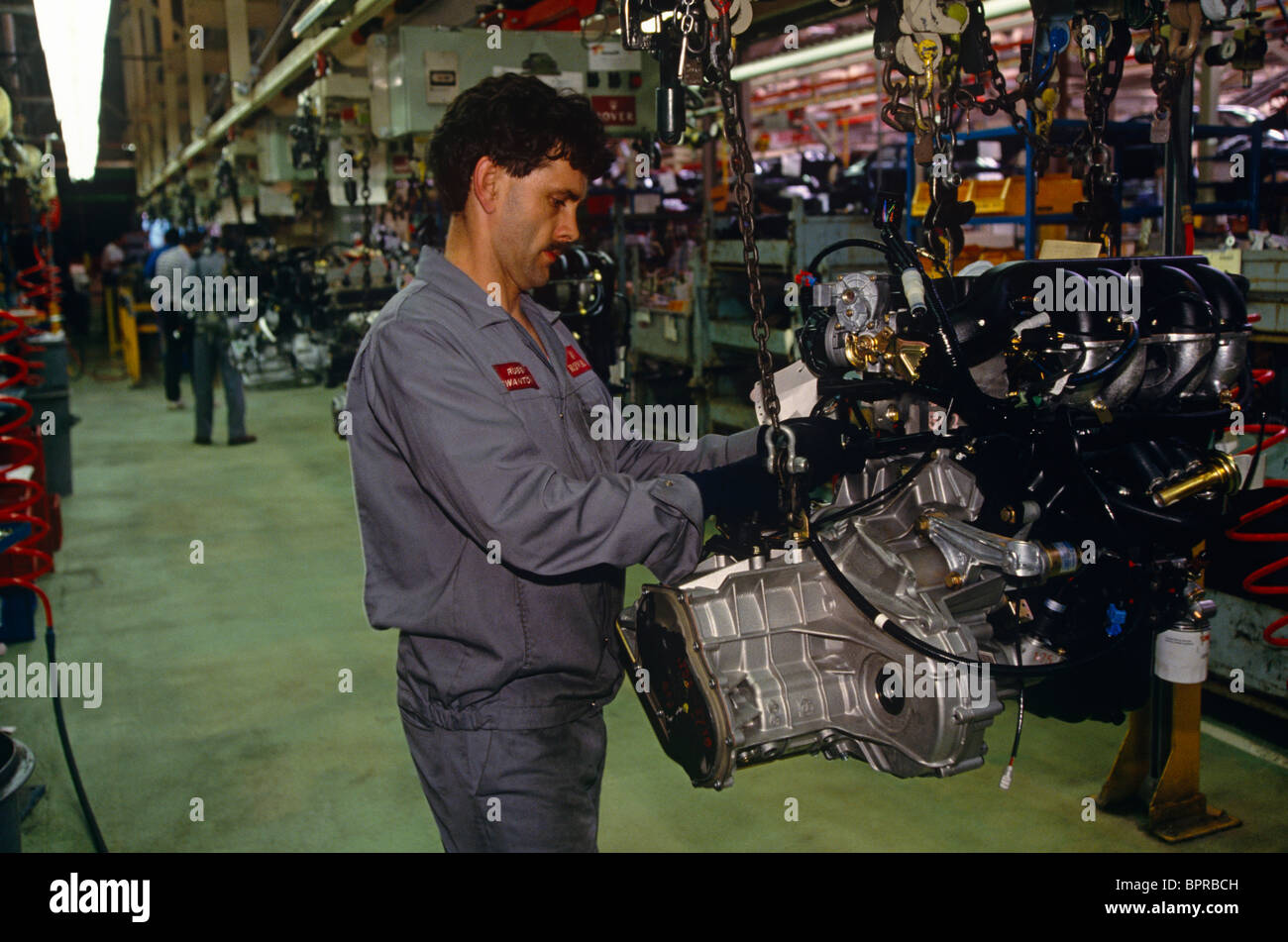 Worker carefully swings car engine for Range Rover 4x4 on the ...