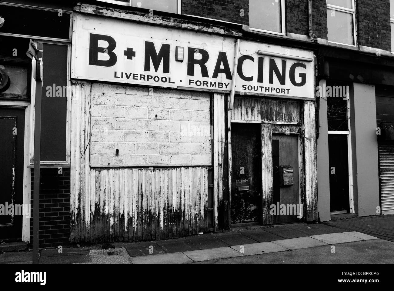 B+M Racing bookies. Businesses along Regent Road ( The Dock Road ) by Liverpool Docks in Merseyside. Stock Photo