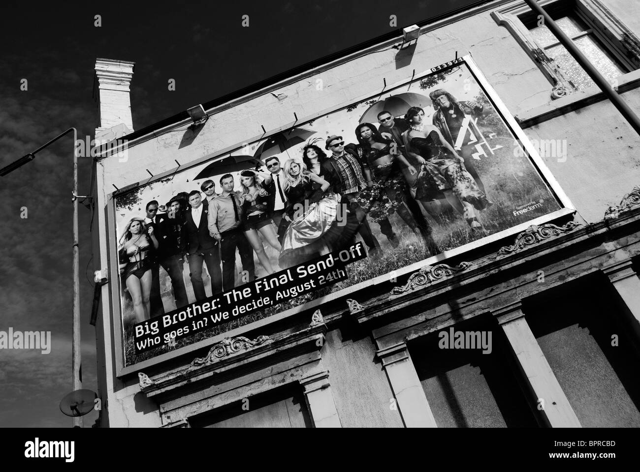 Billboards posted on the side of the closed and decaying former Dominion public house on the Dock Road in Liverpool. Stock Photo