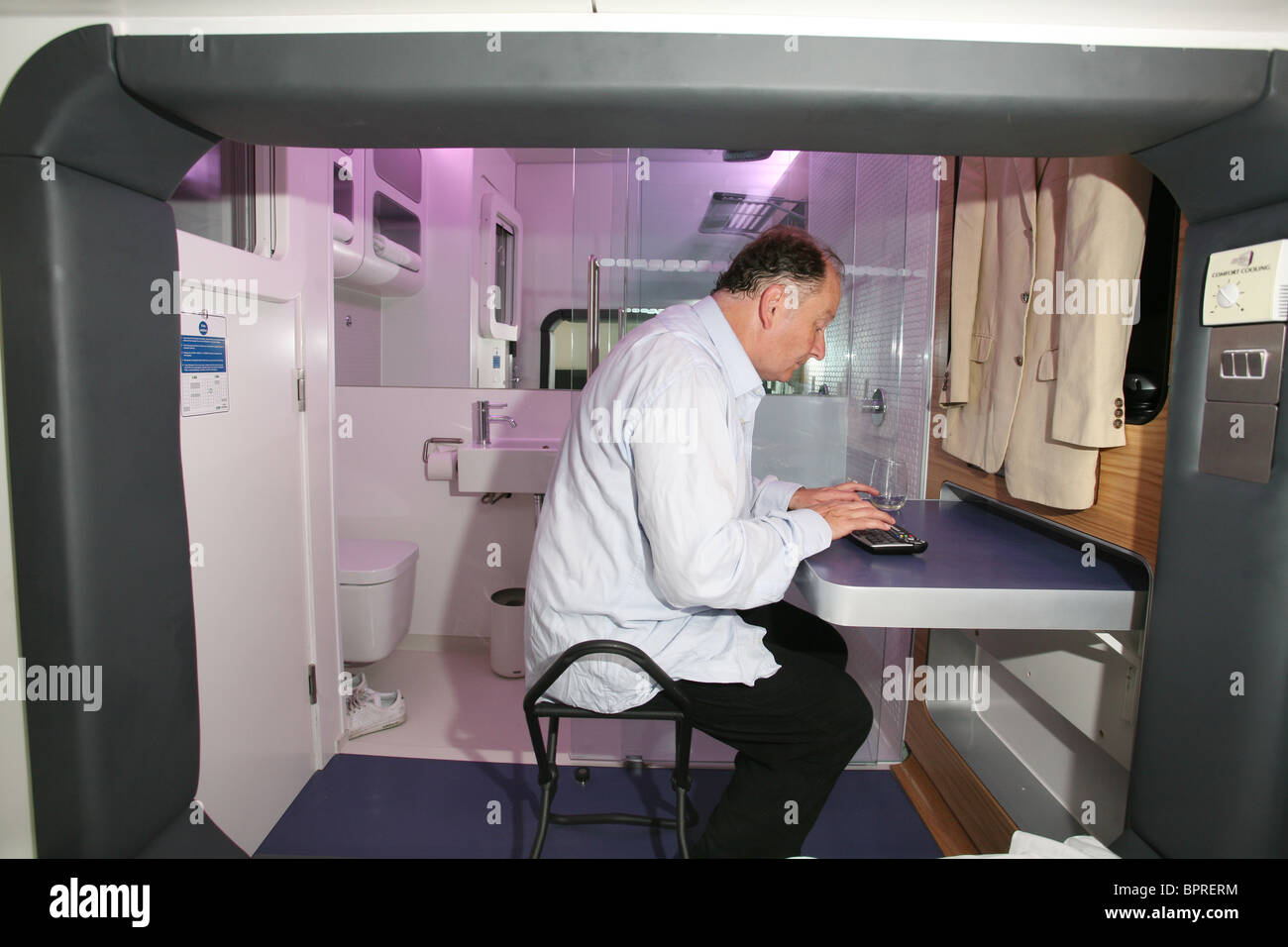 Image shows a man staying at Yotel, a budget hotel made of tiny cabins, Gatwick Airport, England, UK. Photo:Jeff Gilbert Stock Photo