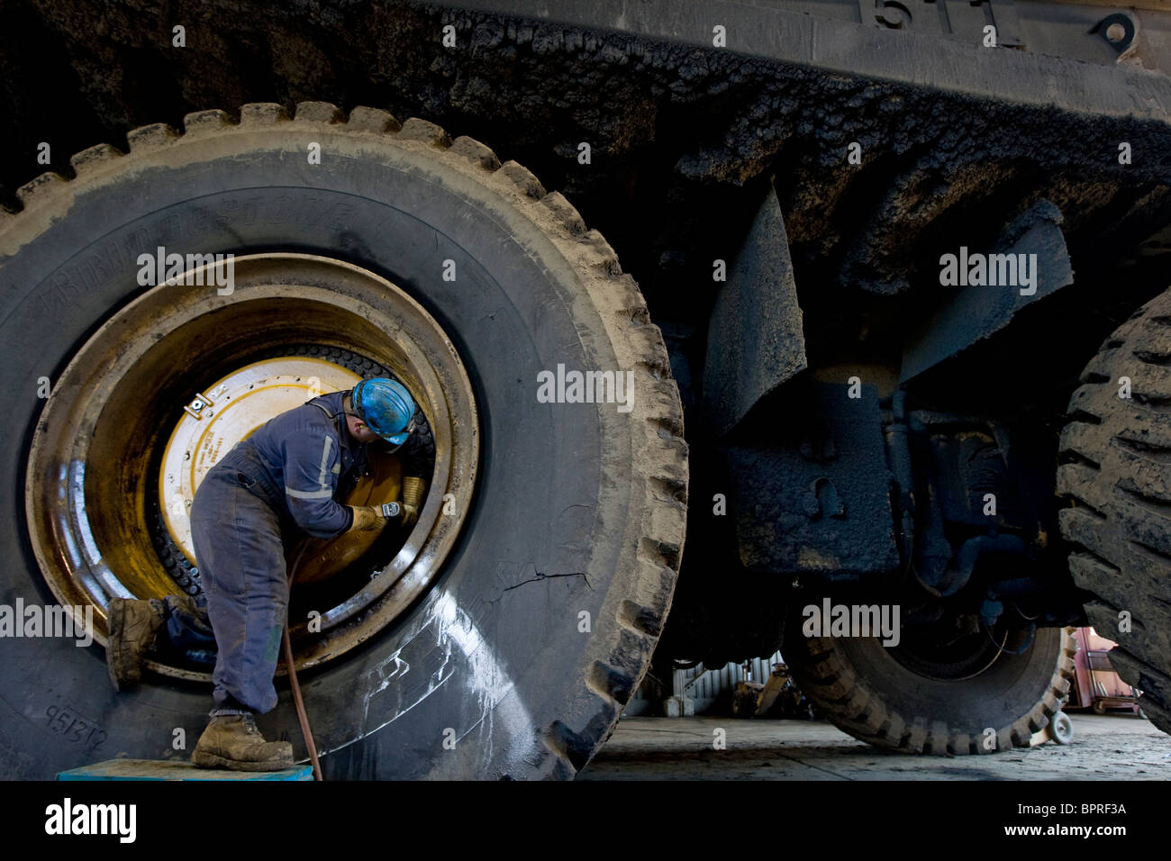 Tire repairman, Suncor Facility, north of Fort McMurray, Alberta