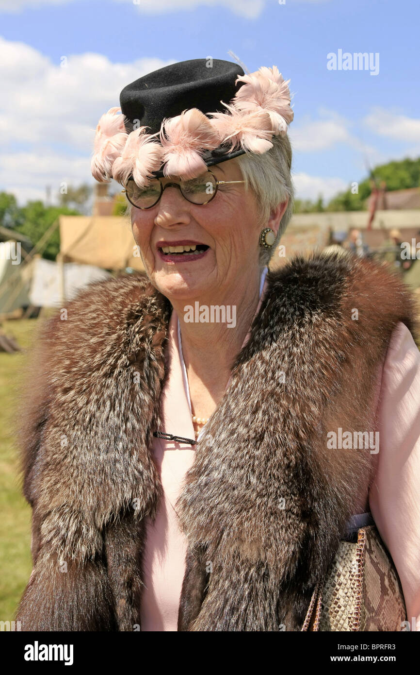 A woman civilian wearing authentic WW2 clothing during a reenactment weekend Stock Photo