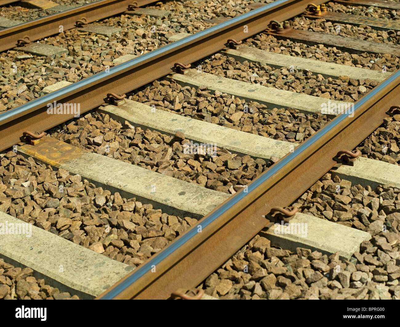 Close up of railway train tracks lines and sleepers England UK United Kingdom GB Great Britain Stock Photo