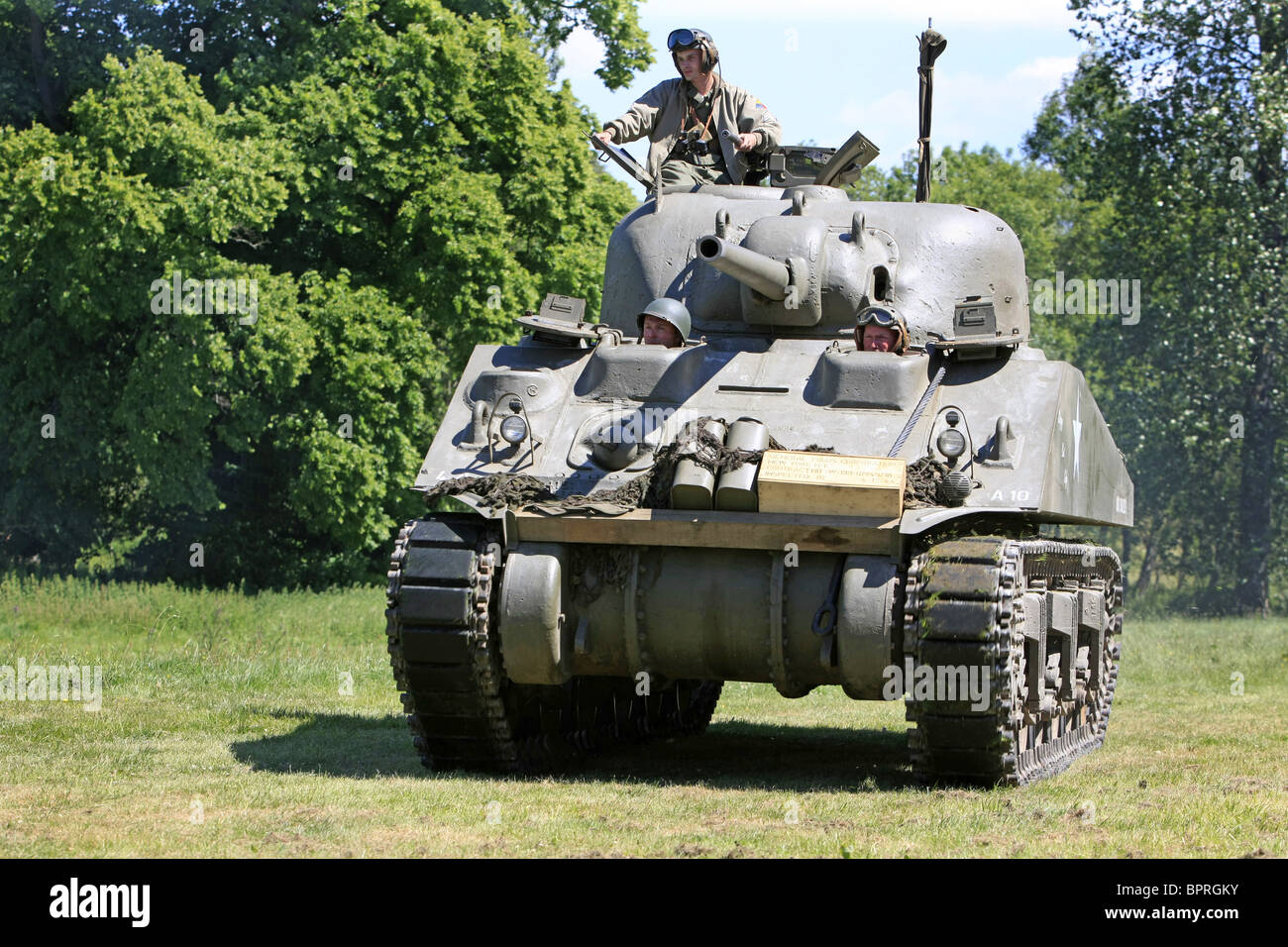 WW2 Reenactment members in a Sherman tank taking part in a mock battle weekend Stock Photo