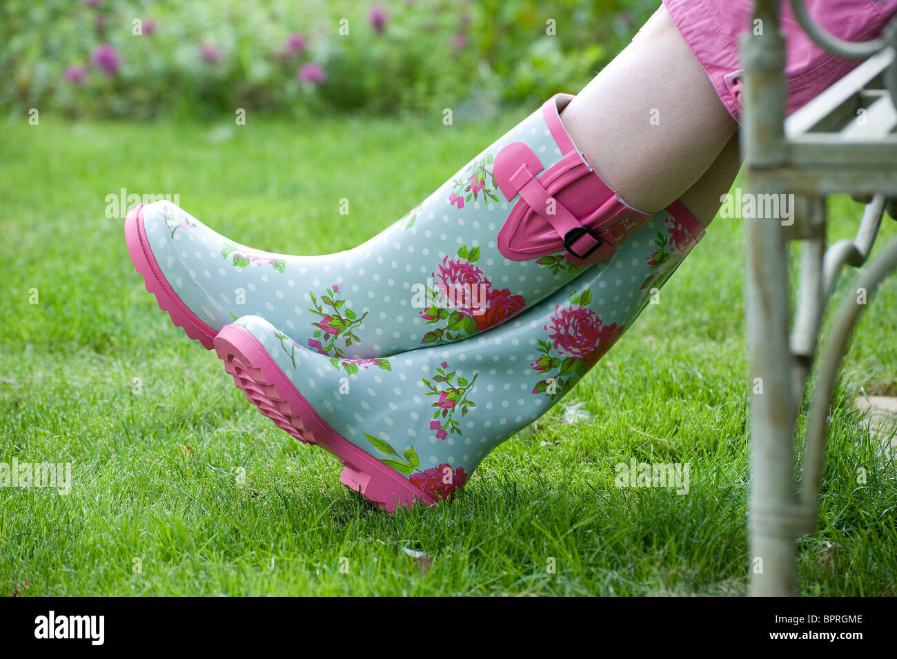 colourful wellington rubber boots in garden Stock Photo