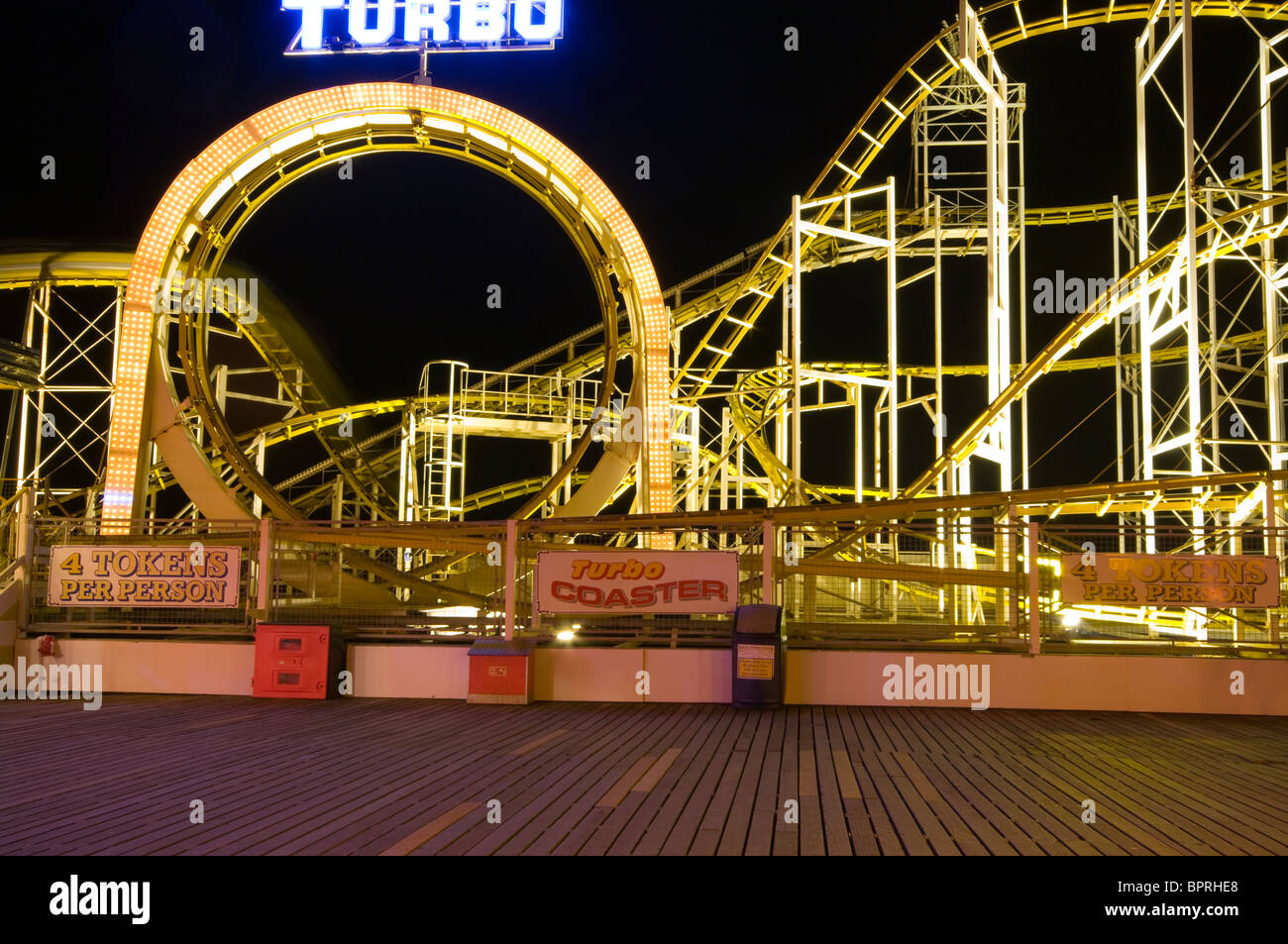 The Turbo Funfair Ride Illuminated At Night On Brighton Pier East Sussex England Stock Photo
