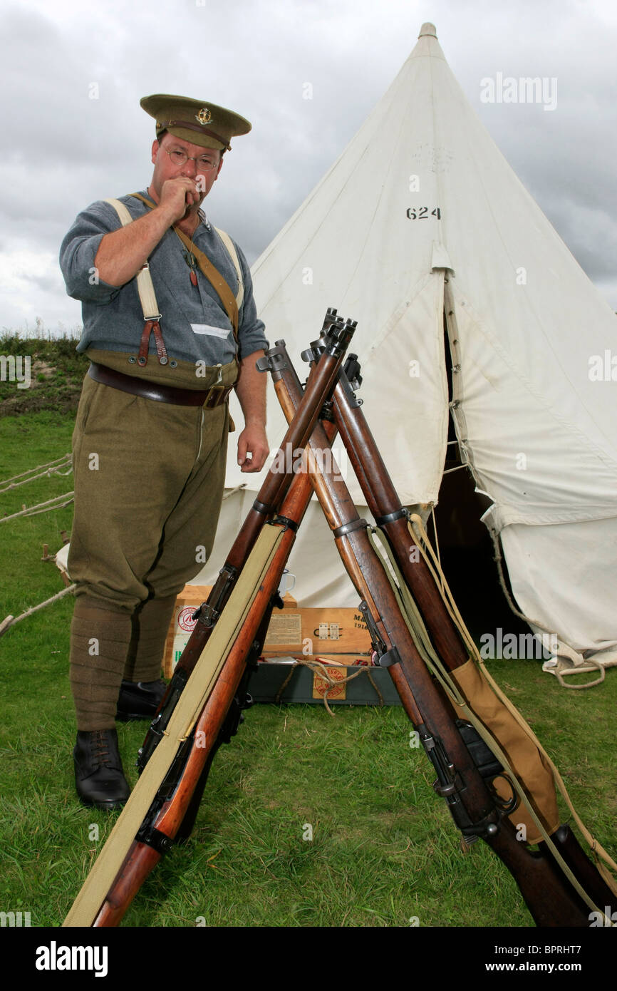 Male reenactment group soldier wearing the uniform of a WW1British Army infantryman posing by his tent Stock Photo