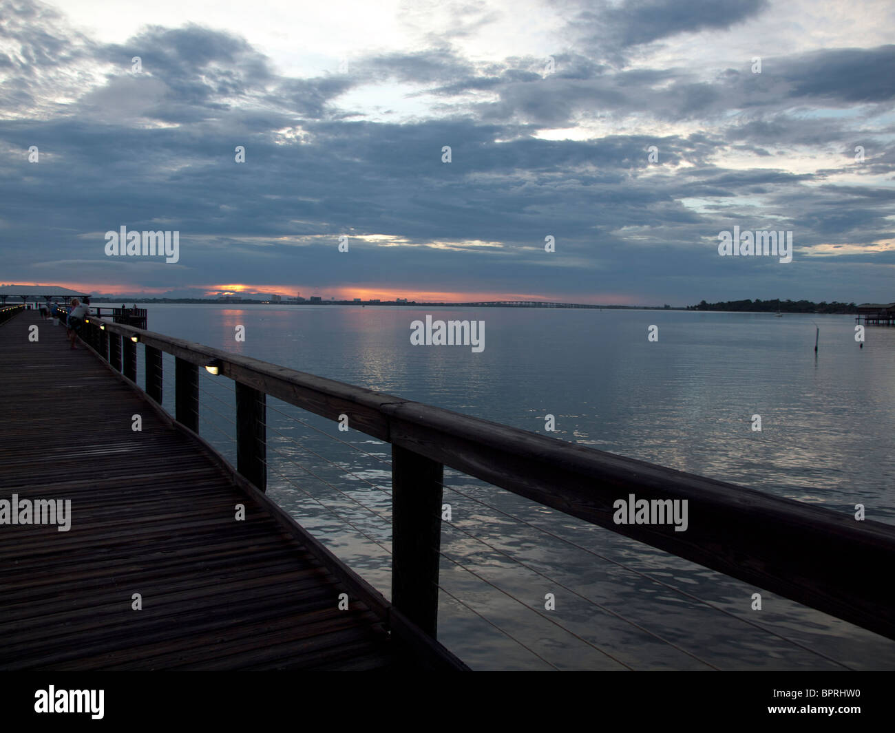 Setting Sun at twilight on the Indian River Lagoon at the Melbourne Beach Pier in Florida Stock Photo