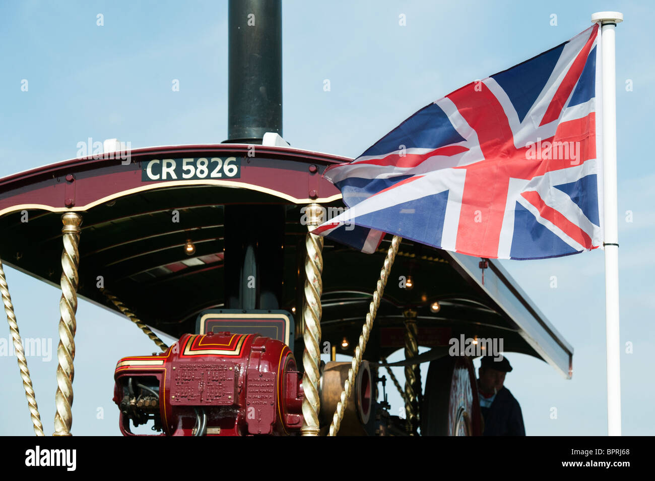 Union Jack flag in front of a Showmans Traction Engine at the Great Dorset steam fair 2010, England Stock Photo