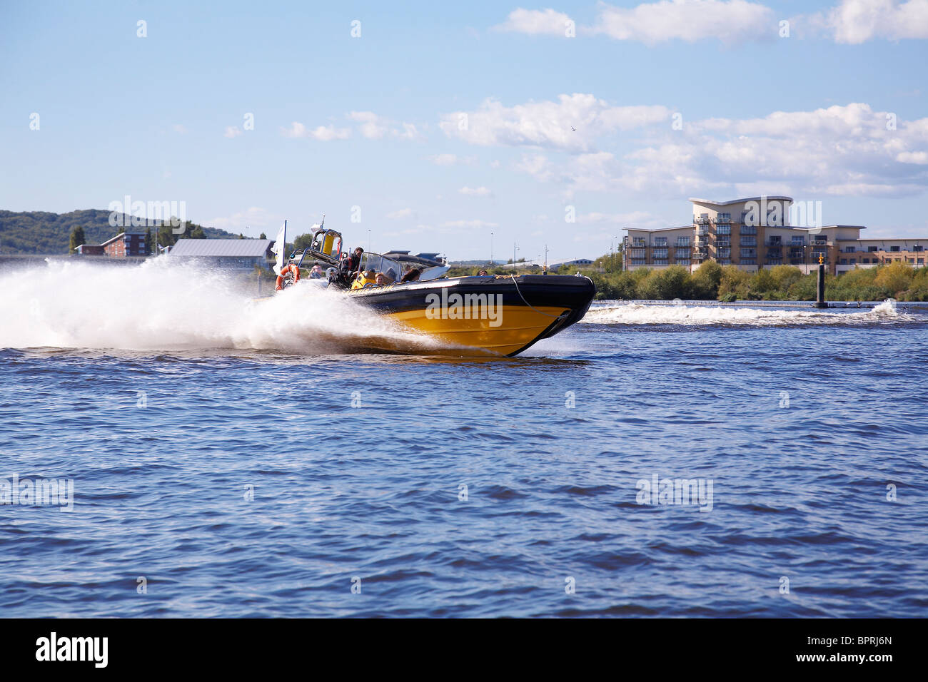 People being taken on a fun excursion in a Rib around Cardiff bay. Stock Photo