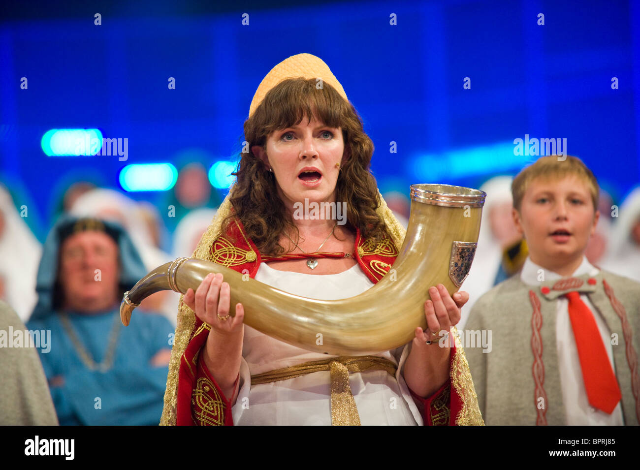 Robed woman carrying Hirlas Horn of Plenty on stage during Gorsedd of Bards Crowning Ceremony National Eisteddfod of Wales 2010 Stock Photo