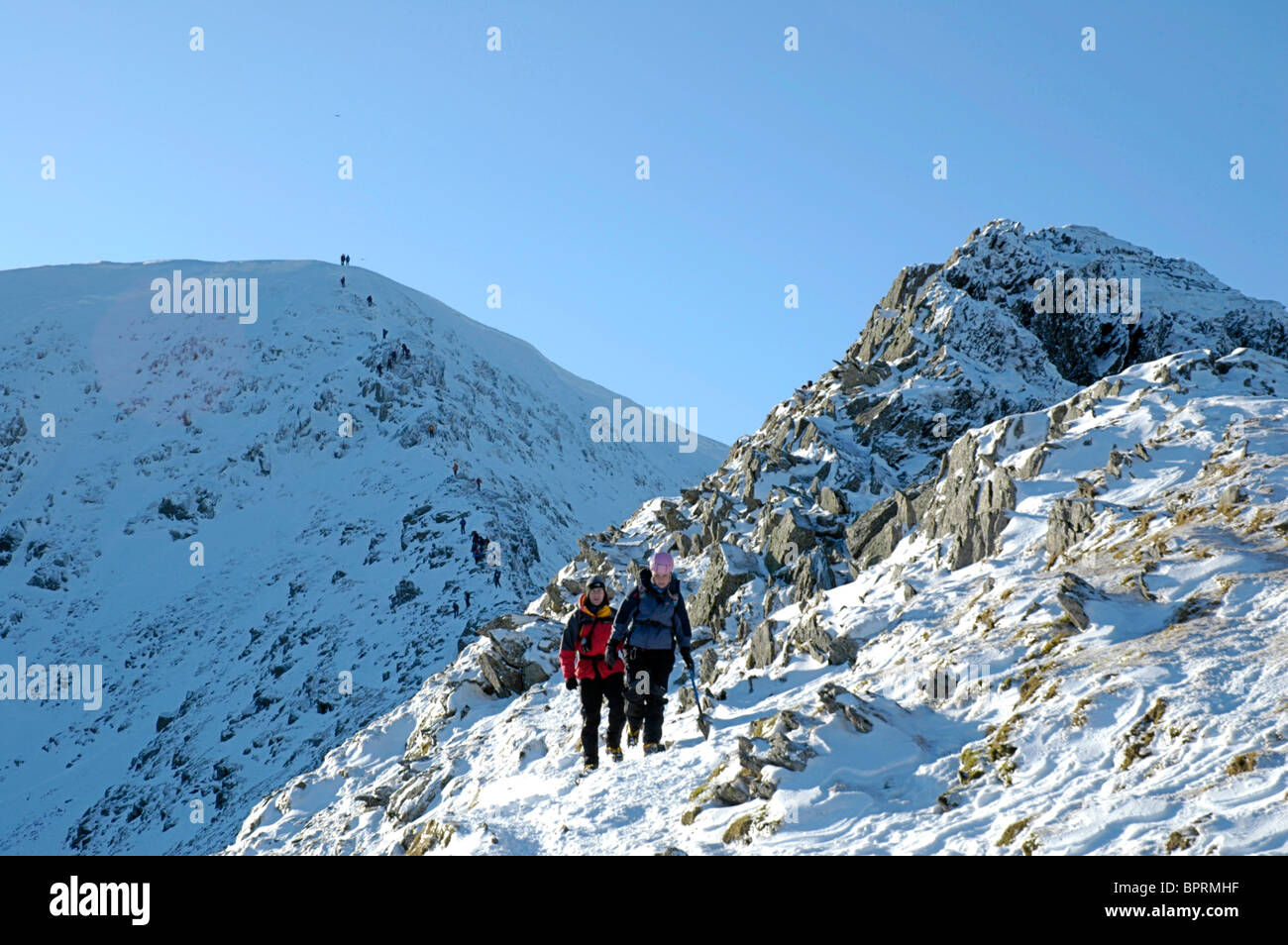 Hill walkers on Swirral Edge, Helvellyn, in the English Lake District Stock Photo