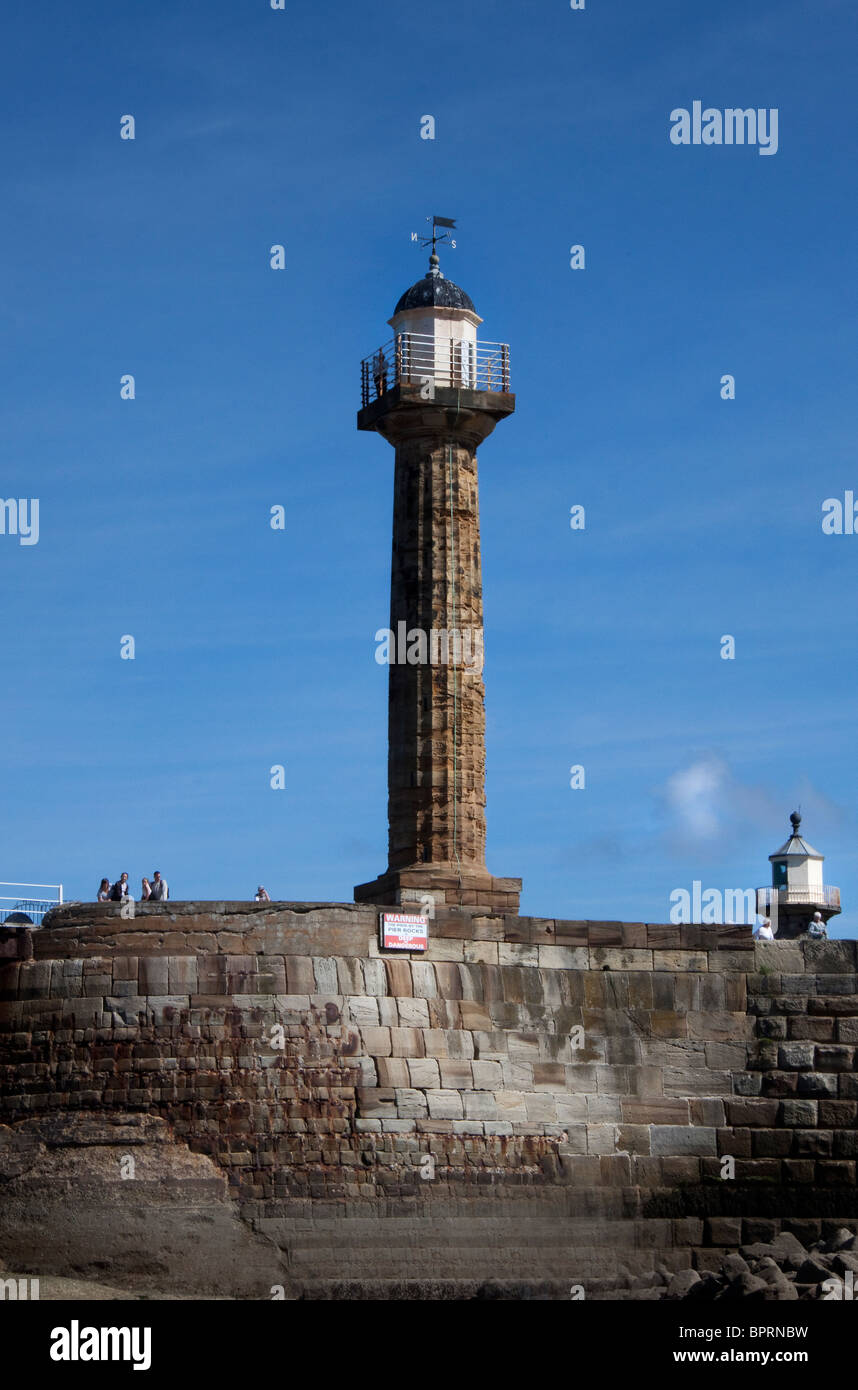 Whitby lighthouse and Pier, featuring blue sky. Stock Photo