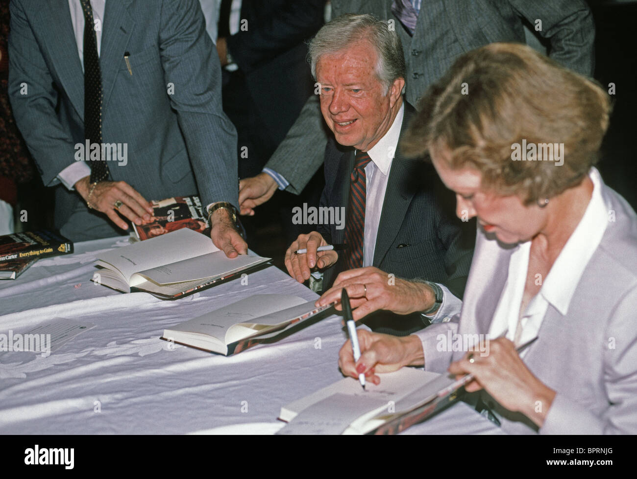 former President, jimmy and rosalynn carter, Jimmy Carter and wife, Rosalynn autograph their book. 1987 Stock Photo