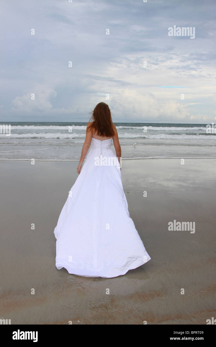 A Woman in a Wedding Dress in the Ocean Stock Photo - Alamy