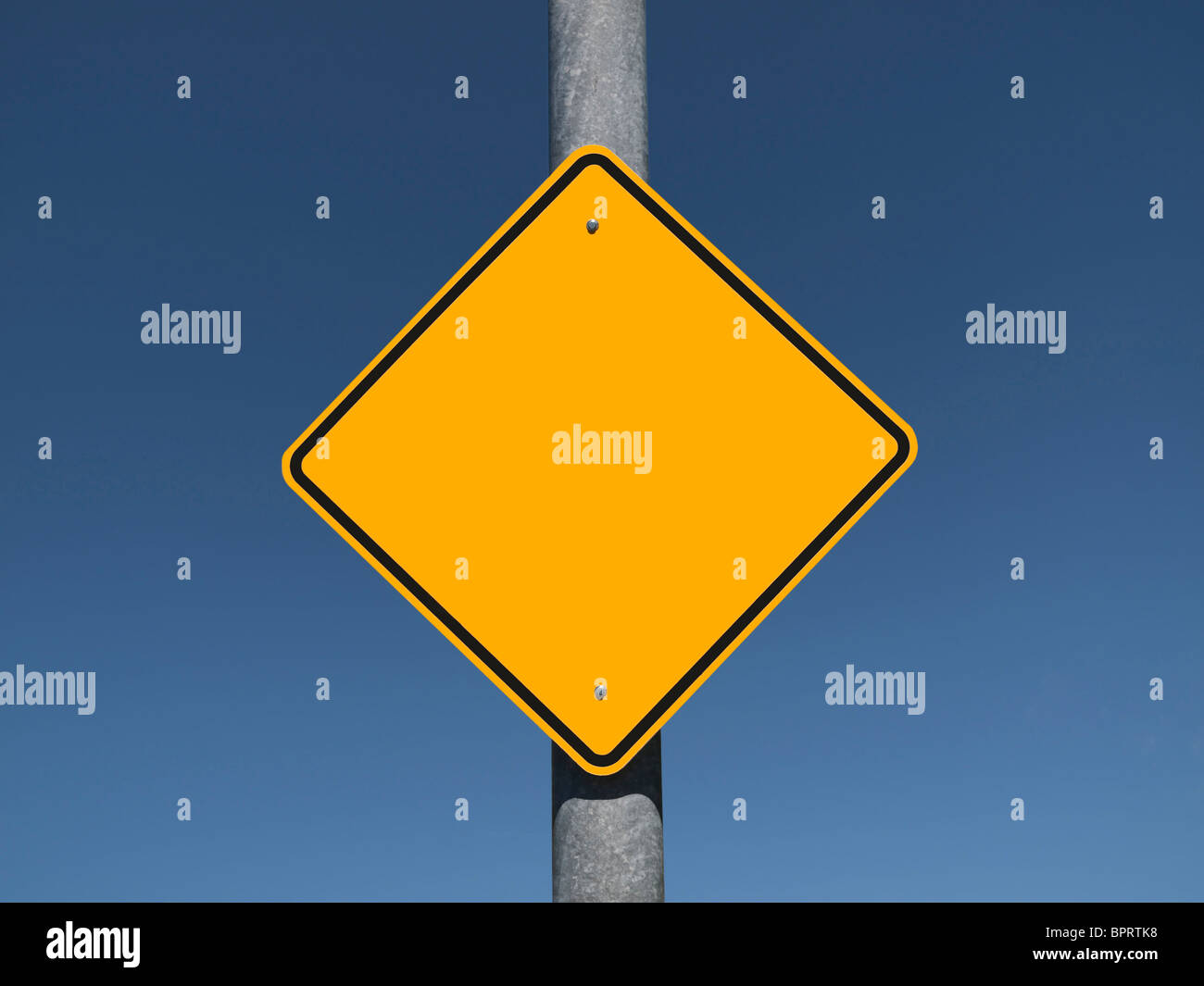Blank caution sign with a deep blue sky. Stock Photo